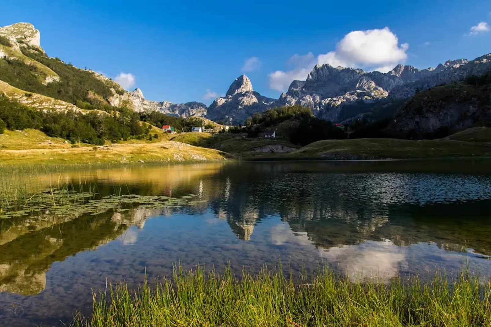 Bukumirsko Lake reflecting the Kuči mountains