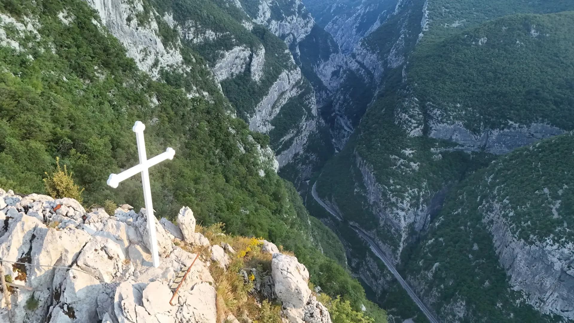 Cross on a cliff above the Morača Canyon road