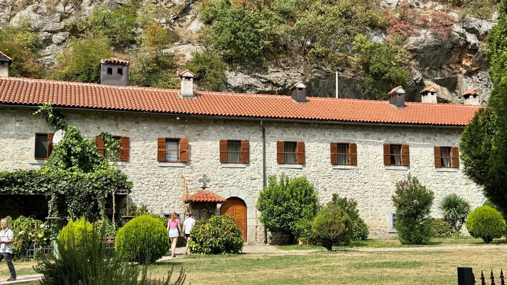 Stone monastery lodgings beneath the cliffs