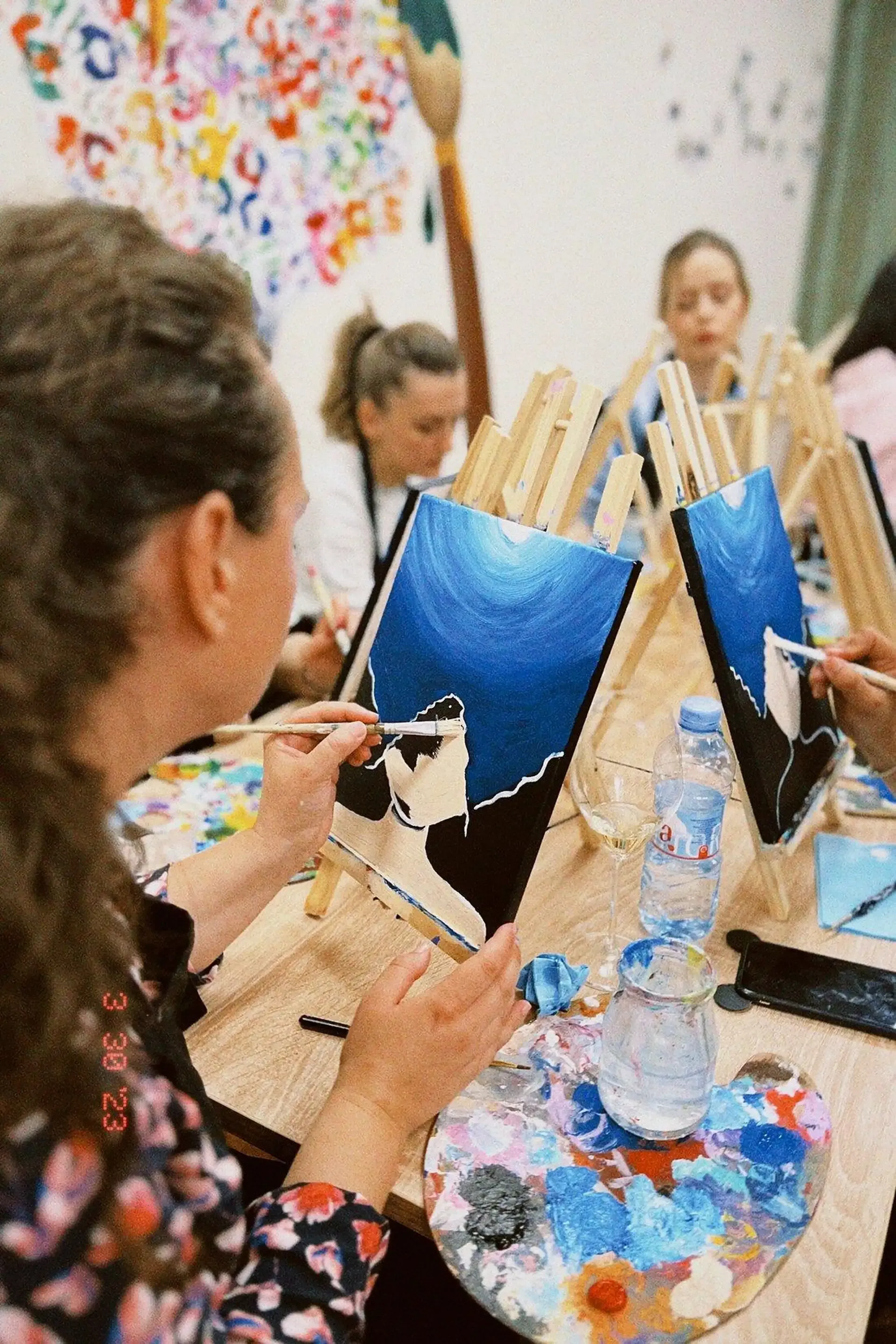 Guest painting a canvas during the workshop